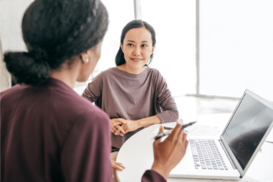 Woman interviewing female job candidate.