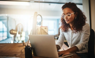 Woman working on laptop.