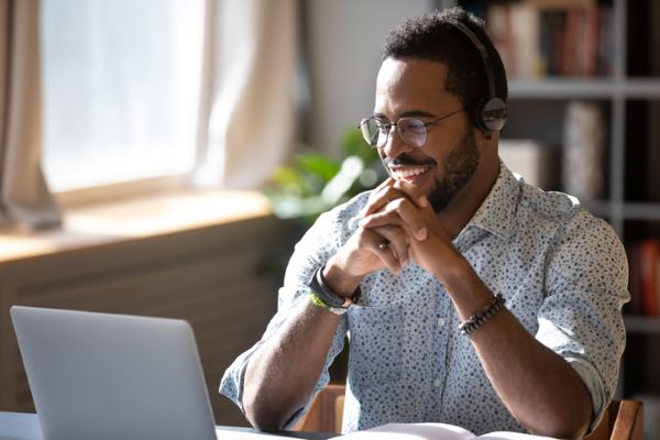 smiling businessman works on his computer