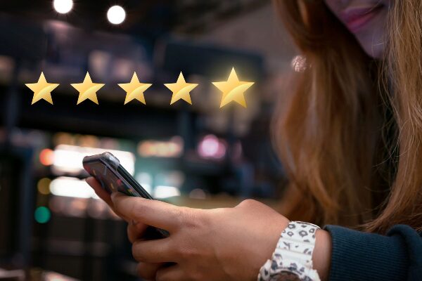 Woman submitting star rating feedback on mobile device