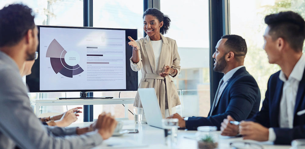 woman presenting in front of co-workers