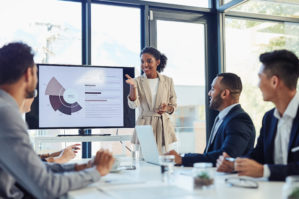 woman presenting in front of co-workers