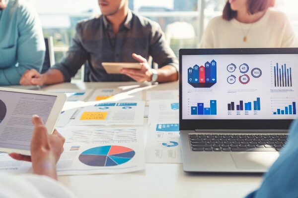 Business people reviewing marketing graphs and charts at a meeting