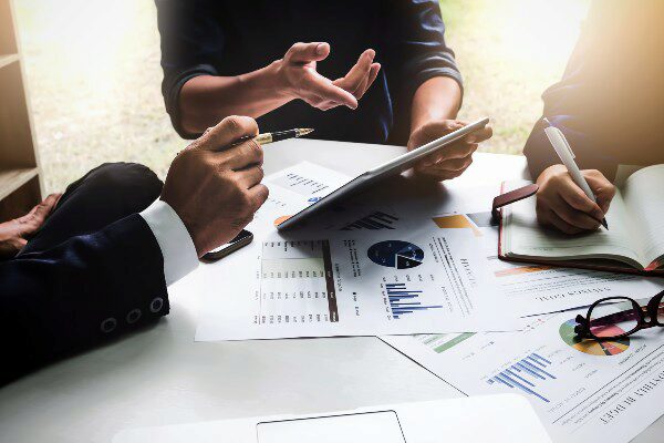 Group of finance professionals going over data during a meeting